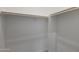 A white walk-in closet with ample shelving and multiple hanging rods at 22670 E Happy Rd, Queen Creek, AZ 85142