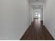 Long hallway featuring hard surface floors and white walls, creating a modern aesthetic at 22670 E Happy Rd, Queen Creek, AZ 85142