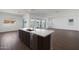 Dark wood kitchen island with stainless sink and dishwasher at 22670 E Happy Rd, Queen Creek, AZ 85142