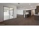 Open-concept kitchen/living area with a sliding glass door leading to the exterior of the home at 22670 E Happy Rd, Queen Creek, AZ 85142