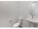 This powder room has a toilet, sink, and mirror at 22670 E Happy Rd, Queen Creek, AZ 85142