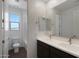 Bathroom featuring double sinks, dark wood cabinets, and a tub with a window at 23128 E Watford Dr, Queen Creek, AZ 85142