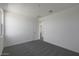 Bright bedroom with soft carpet, a white door and walls, and a large window at 23128 E Watford Dr, Queen Creek, AZ 85142