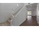 Bright entryway with a staircase featuring white railings, leading to the upper level at 23128 E Watford Dr, Queen Creek, AZ 85142