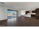 Open-concept living room with wood-look floors and sliding glass doors at 23128 E Watford Dr, Queen Creek, AZ 85142