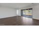 Bright living room featuring wood-look tile flooring and large sliding glass doors at 23128 E Watford Dr, Queen Creek, AZ 85142