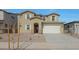 Two-story home with a two-car garage, desert landscaping, and a welcoming front entrance at 23136 E Watford Dr, Queen Creek, AZ 85142