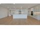 Well-lit kitchen showcasing a central island, stainless steel range hood, and modern cabinetry at 23136 E Watford Dr, Queen Creek, AZ 85142