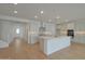 Open-concept kitchen with a center island, stainless steel appliances, and light wood-look flooring at 23136 E Watford Dr, Queen Creek, AZ 85142