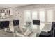 Modern dining area with a glass table and a view into the kitchen at 2317 W Danbury Rd, Phoenix, AZ 85023