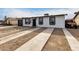 White house with black garage door and landscaping at 2317 W Danbury Rd, Phoenix, AZ 85023