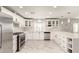 Modern white kitchen with stainless steel appliances at 2317 W Danbury Rd, Phoenix, AZ 85023