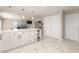 Modern kitchen with white cabinets, a large island, and ample storage at 2317 W Danbury Rd, Phoenix, AZ 85023