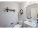 Clean and simple half bathroom with a pedestal sink and decorative accents at 23619 N 21St St, Phoenix, AZ 85024