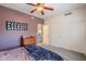 Spacious bedroom with ceiling fan and double doors at 23619 N 21St St, Phoenix, AZ 85024