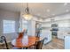 Bright dining area with wood table and four chairs near kitchen at 23619 N 21St St, Phoenix, AZ 85024