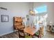 Bright dining room featuring a rustic wooden table and antique hutch at 23619 N 21St St, Phoenix, AZ 85024