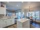 Bright kitchen with an island, white cabinets, and a breakfast area at 23619 N 21St St, Phoenix, AZ 85024