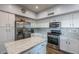 Island kitchen with granite countertops and white cabinetry at 23619 N 21St St, Phoenix, AZ 85024