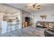 Open living space with a kitchen island, seating area and a large TV at 23619 N 21St St, Phoenix, AZ 85024