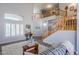 Two-story living room with hardwood floors, a staircase, and a cozy sitting area at 23619 N 21St St, Phoenix, AZ 85024