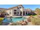 Kidney shaped pool with waterfall feature at 23619 N 21St St, Phoenix, AZ 85024