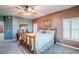 Primary bedroom with king bed, plantation shutters, and ceiling fan at 23619 N 21St St, Phoenix, AZ 85024