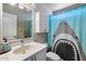 Bathroom with a sink, toilet, and shower with a shark-themed curtain at 2472 W Crocus Dr, Phoenix, AZ 85023