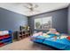 bedroom with a twin bed, bookshelf, and colorful storage at 2472 W Crocus Dr, Phoenix, AZ 85023