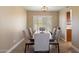 Dining room with six chairs and a large window with plantation shutters at 2472 W Crocus Dr, Phoenix, AZ 85023