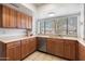 Kitchen with stainless steel dishwasher and sink, wood cabinets, and window at 2472 W Crocus Dr, Phoenix, AZ 85023