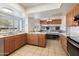 Spacious kitchen with island, wood cabinets, and stainless steel appliances at 2472 W Crocus Dr, Phoenix, AZ 85023