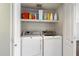 Convenient laundry closet with washer and dryer and extra shelving at 2472 W Crocus Dr, Phoenix, AZ 85023