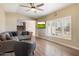 Living room with L-shaped sofa, large window, and wood floors at 2472 W Crocus Dr, Phoenix, AZ 85023