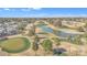 Aerial view of community, featuring a golf course, lake, and numerous residences at 2524 S El Paradiso Dr # 74, Mesa, AZ 85202