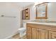 Clean bathroom with wood cabinets, granite countertop, and a mirror at 2524 S El Paradiso Dr # 74, Mesa, AZ 85202