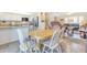 Bright dining area with wood table and white chairs, open to kitchen at 2524 S El Paradiso Dr # 74, Mesa, AZ 85202