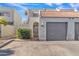 Townhouse with a grey garage door and gated entryway at 2524 S El Paradiso Dr # 74, Mesa, AZ 85202