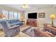 Comfortable living room with blue leather sofa and wood media cabinet at 2524 S El Paradiso Dr # 74, Mesa, AZ 85202