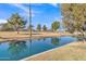 Serene waterway view with lush green landscaping and mature trees at 2524 S El Paradiso Dr # 74, Mesa, AZ 85202