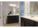 Double vanity bathroom with dark brown cabinets and shower at 2605 E San Thomas Dr, Casa Grande, AZ 85194