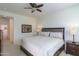 King-size bed in a well lit bedroom with ensuite access at 2605 E San Thomas Dr, Casa Grande, AZ 85194