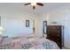 Bedroom with queen bed, dresser, and ceiling fan at 2605 E San Thomas Dr, Casa Grande, AZ 85194