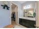 Bathroom with dark vanity, walk-in closet, and a large mirror at 2622 E Marcos Dr, Casa Grande, AZ 85194