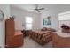 Bedroom with a double bed, wood furniture, and ceiling fan at 2622 E Marcos Dr, Casa Grande, AZ 85194