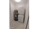 Stackable washer and dryer with water heater in compact laundry room at 2834 S Extension Rd # 1032, Mesa, AZ 85210