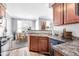 Cozy kitchen with wood cabinetry and stainless steel appliances, seamlessly flowing into the dining area at 29606 N Tatum Blvd # 216, Cave Creek, AZ 85331