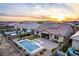 House with pool and patio; aerial sunset view at 30255 N 115Th Dr, Peoria, AZ 85383