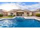 Relax by the inviting pool with a view of the home's exterior at 30255 N 115Th Dr, Peoria, AZ 85383