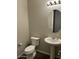 Simple bathroom with pedestal sink and toilet at 30255 N 115Th Dr, Peoria, AZ 85383